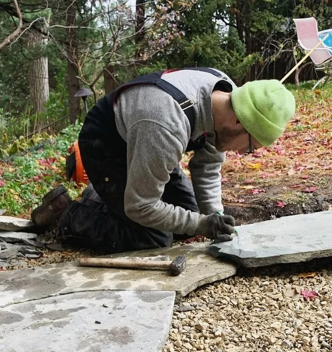 Cody, owner of GO Landscaping, working on a stone project