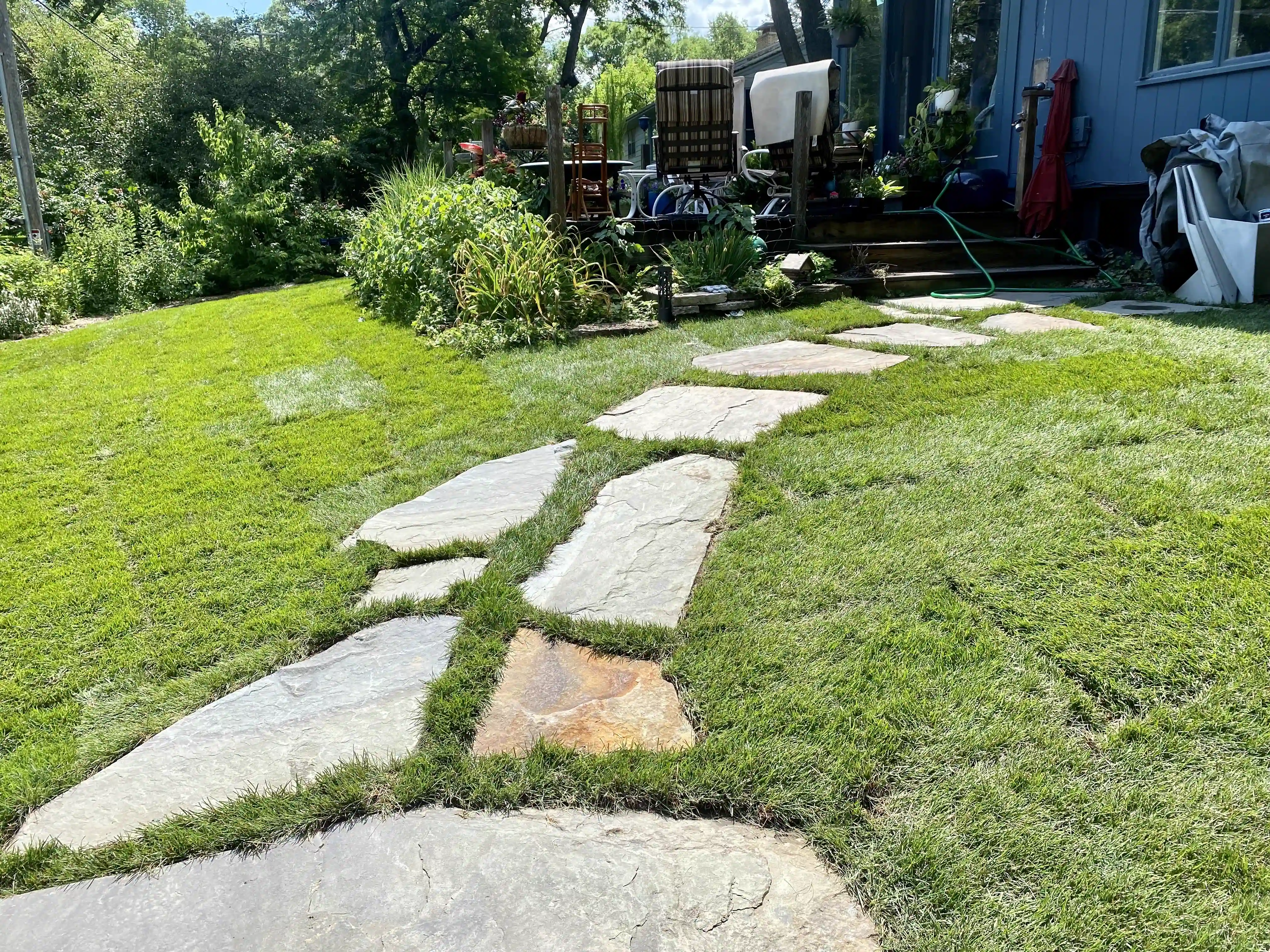 Lawn with stepping stones and fresh sod by GO Landscaping in Dane County, WI