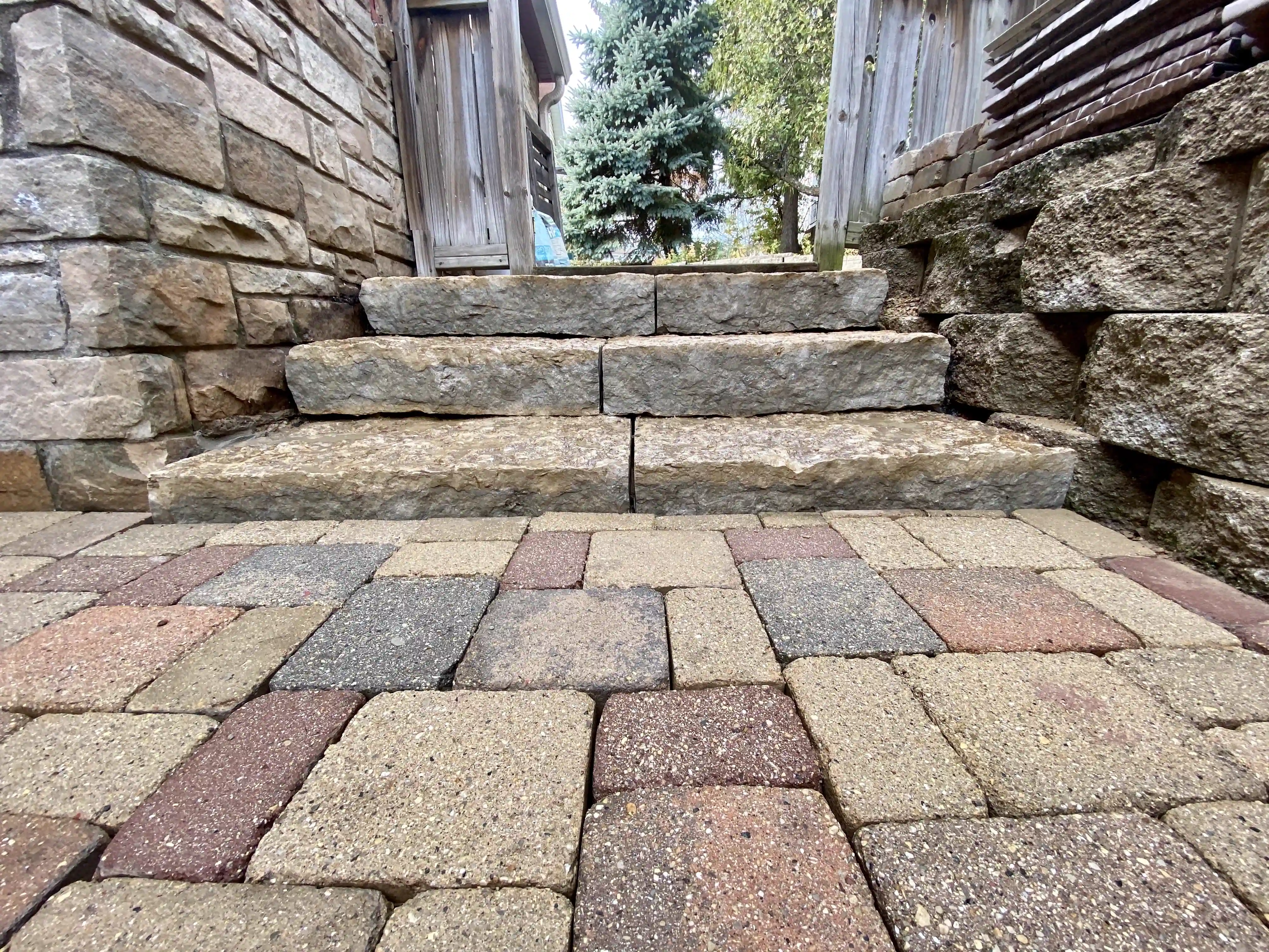Natural stone steps, retaining wall, and paver patio